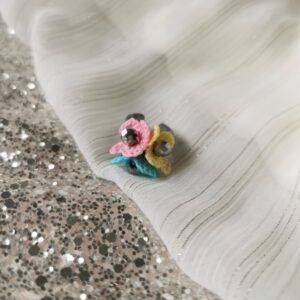 ring with blue yellow pink crochet flowers