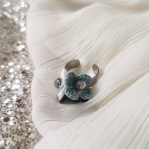 ring with white blue black crochet flowers